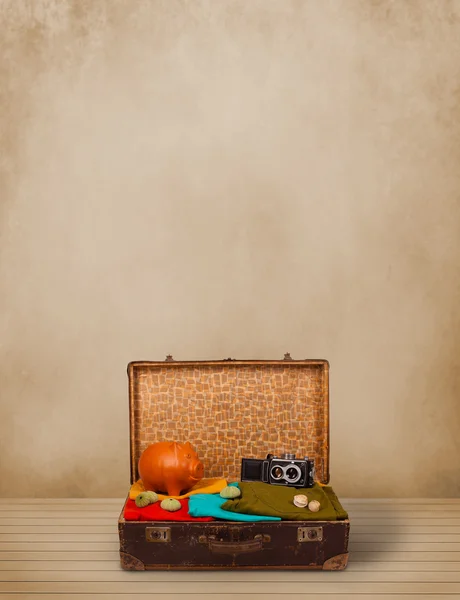 Retro tourist luggage with colorful clothes and copyspace — Stock Photo, Image