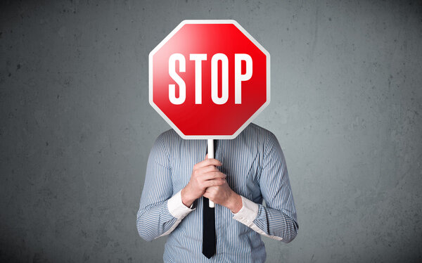 Businessman holding a stop sign