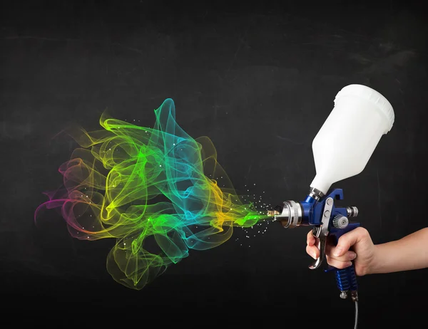 Painter working with airbrush and paints colorful paint — Stock Photo, Image