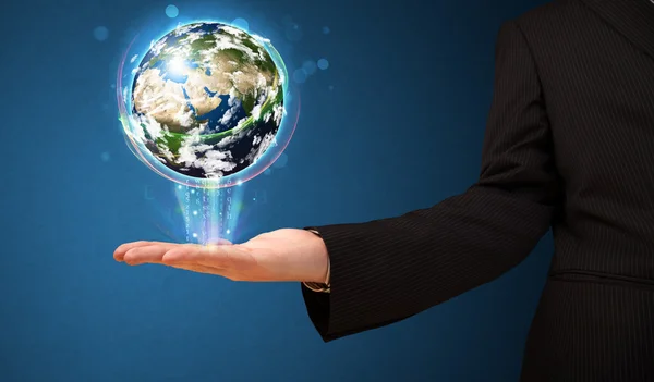 Businessman holding a glowing earth globe — Stock Photo, Image