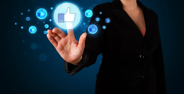 Young businesswoman pressing thumbs up button on modern social n — Stock Photo, Image