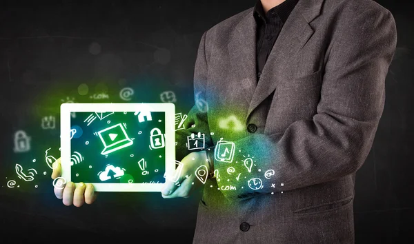 Person holding tablet with green media icons and symbols — Stock Photo, Image