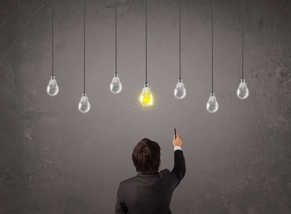 Businness guy in front of idea light bulbs concept — Stock Photo, Image