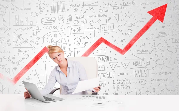 Business woman sitting at table with market diagrams — Stock Photo, Image