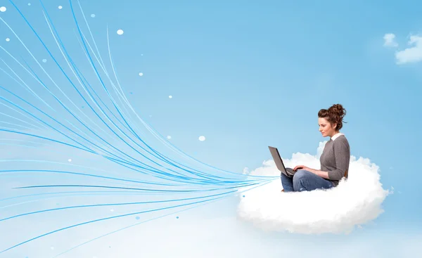 Young woman sitting in cloud with laptop — Stock Photo, Image