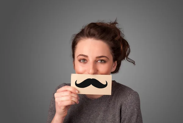 Feliz linda chica sosteniendo papel con bigote dibujo —  Fotos de Stock