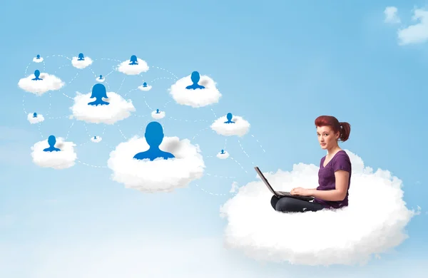 Young woman sitting in cloud with laptop — Stock Photo, Image