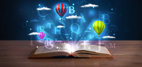 Open book with glowing fantasy abstract clouds and balloons — Stock Photo, Image