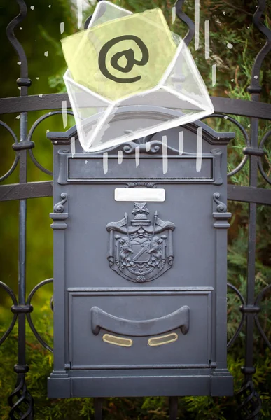Konvolut med email tegn falder i postkasse - Stock-foto