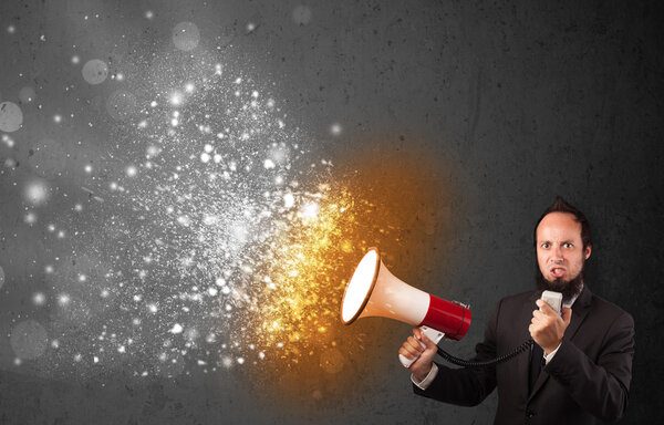 Guy shouting into megaphone and glowing energy particles explode