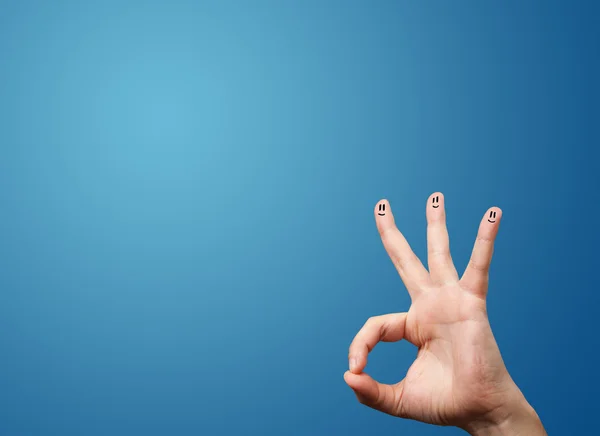 Alegre sonriente cara dedos mirando vacío azul fondo copia — Foto de Stock