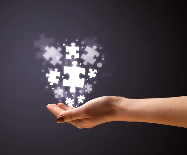 Puzzle pieces in the hand of a woman — Stock Photo, Image