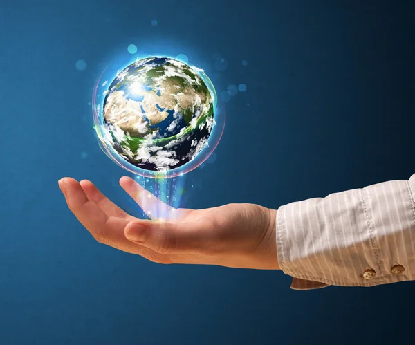 Woman holding a glowing earth globe — Stock Photo, Image