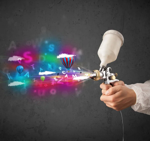 Worker with airbrush and colorful abstract clouds and balloons — Stock Image Worker with airbrush and colorful abstract clouds and balloons Stock Image