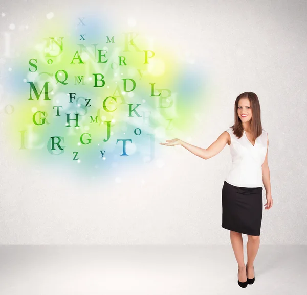 Business women with glowing letter concept — Stock Photo, Image