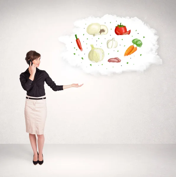 Young girl presenting nutritional cloud with vegetables — Stock Photo, Image