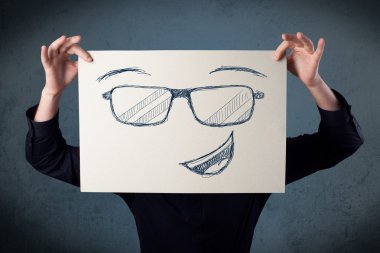 bir kağıt ile gülen yüz onun hea önünde tutan işadamı