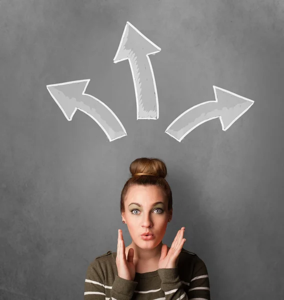 Young woman thinking with arrows above her head — Stock Photo, Image