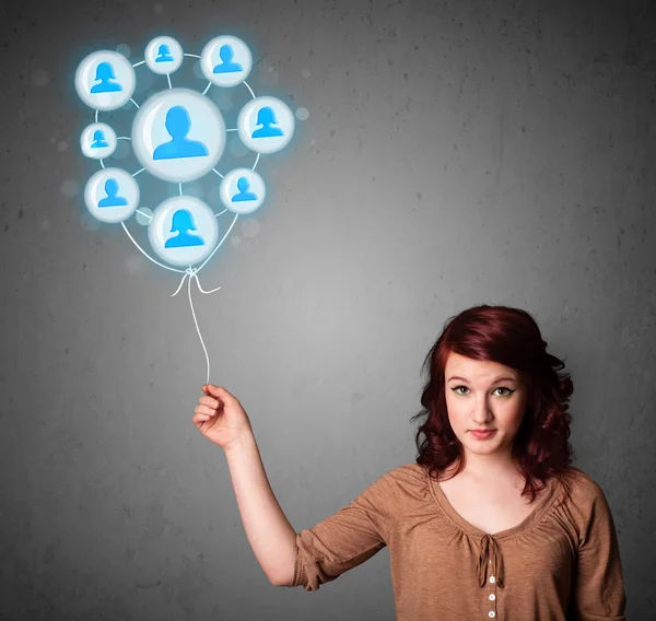 Woman holding social network balloon — Stock Photo, Image