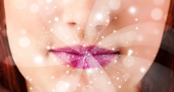 Pretty woman lips blowing abstract white lights — Stock Photo, Image