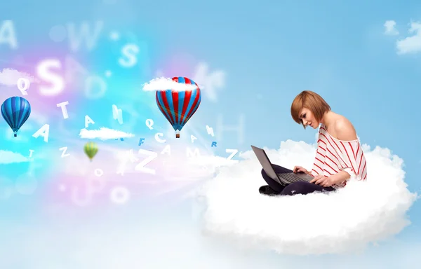 Young woman sitting in cloud with laptop — Stock Photo, Image