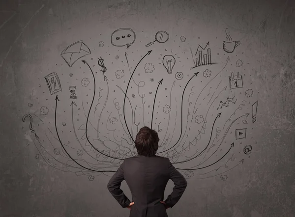 Businessman in front of a chalkboard deciding with arrows and si — Stock Photo, Image