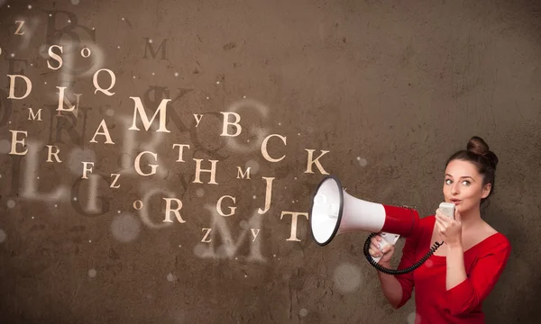 Young girl shouting into megaphone and text come out — Stock Photo, Image