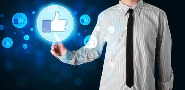 Handsome person pressing thumbs up button on modern social netwo — Stock Photo, Image