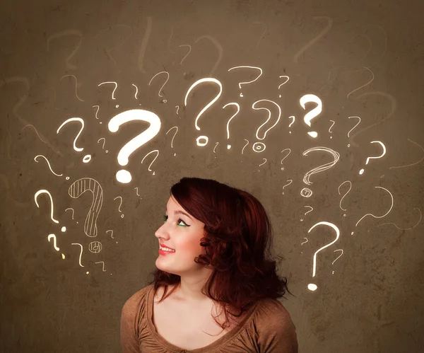 Girl with question mark symbols around her head — Stock Photo, Image