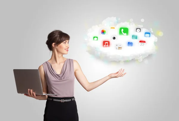 Young woman presenting cloud with colorful app icons and symbols — Stock Photo, Image