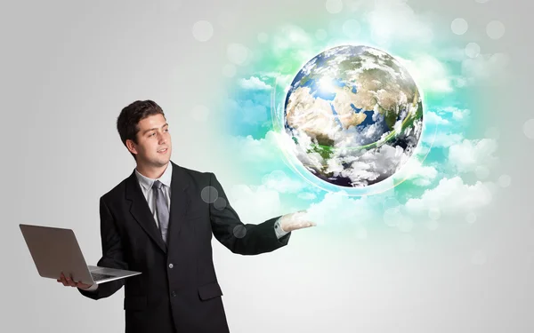 Young man with earth and cloud concept — Stock Photo, Image