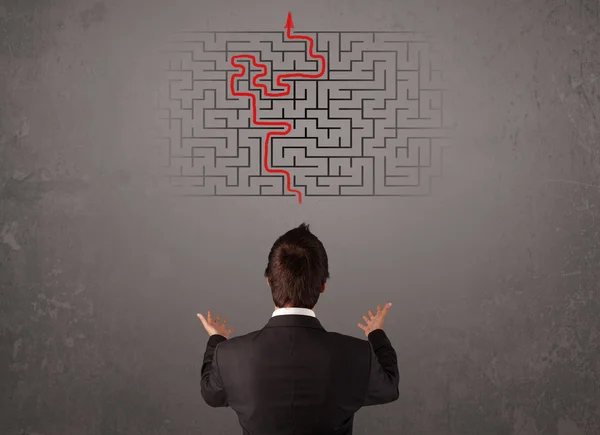 Business man looking at a maze and the way out — Stock Photo, Image