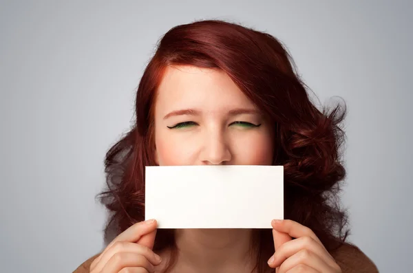 Cute girl holding white card at front of her lips with copy spac — Stock Photo, Image