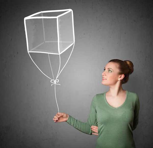 Mujer sosteniendo un globo cubo —  Fotos de Stock