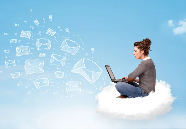 Young woman sitting in cloud with laptop — Stock Photo, Image