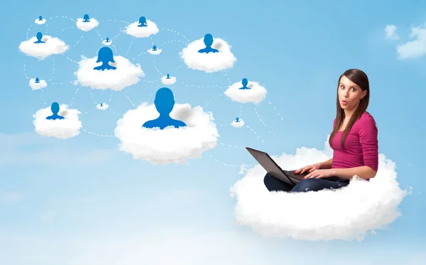 Young woman sitting in cloud with laptop — Stock Photo, Image