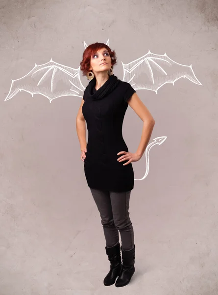 Young girl with devil horns and wings drawing — Stock Photo, Image