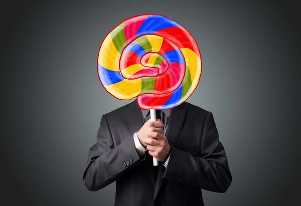 Businessman holding a lollipop — Stock Photo, Image