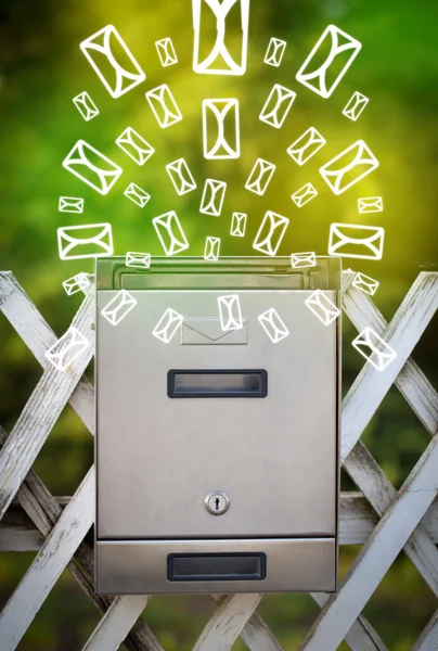 Mailbox with letter icons on glowing green background — Stock Photo, Image