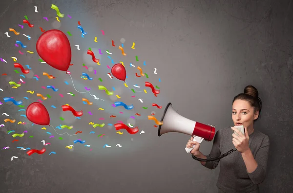 Young girl having fun, shouting into megaphone with balloons — Stock Photo, Image