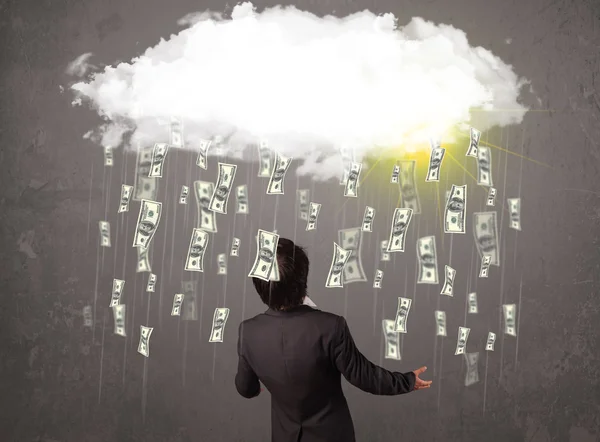 Business man in suit looking at cloud with falling money — Stock Photo, Image