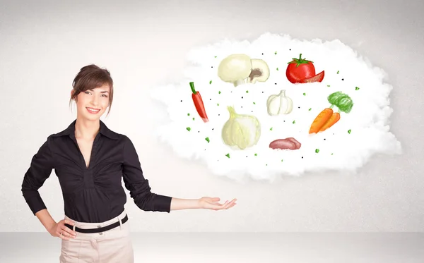 Menina apresentando nuvem nutricional com legumes — Fotografia de Stock