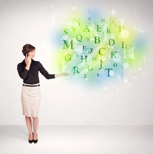 Business women with glowing letter concept — Stock Photo, Image