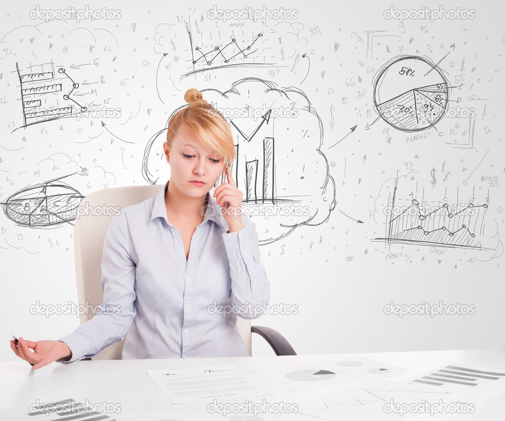 Business woman sitting at table with hand drawn graph charts