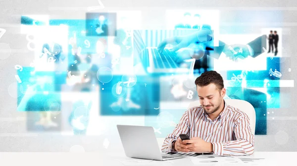 Business person vid skrivbordet med moderna tech bilder i bakgrunden — Stockfoto