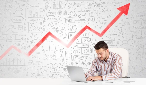 Business man sitting at table with market diagrams — Stock Photo, Image
