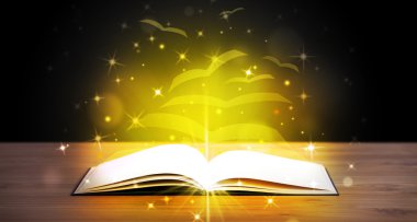 Altından parlak uçan kağıt sayfaları olan açık bir kitap
