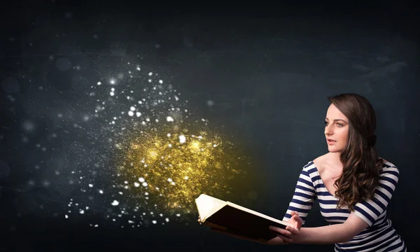 Young lady reading a magical book — Stock Photo, Image