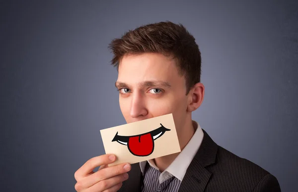 Man holding card with funny smiley — Stock Photo, Image