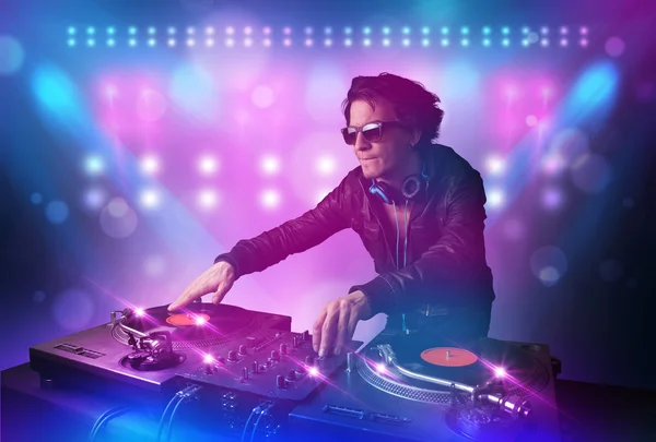 Disc jockey mixing music on turntables on stage with lights and — Stock Photo, Image